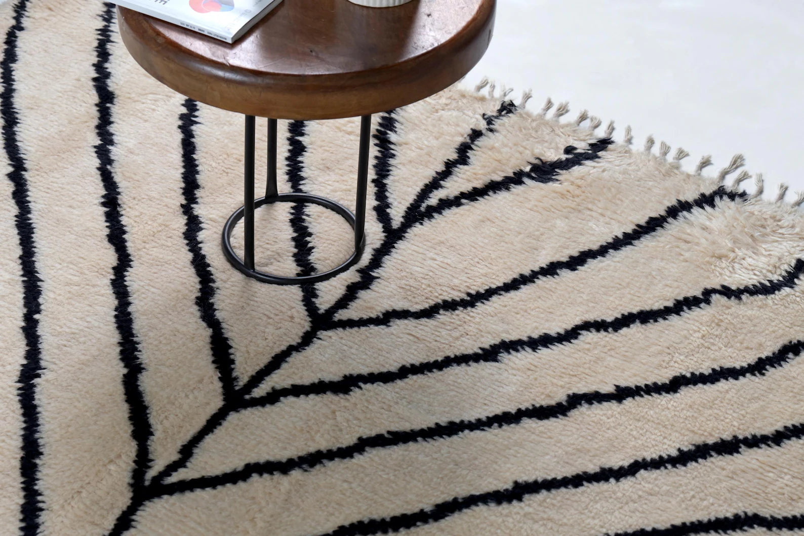 Top perspective of Stemline Moroccan_hand_knotted Rug showing complete leaf-inspired black linear geometry.