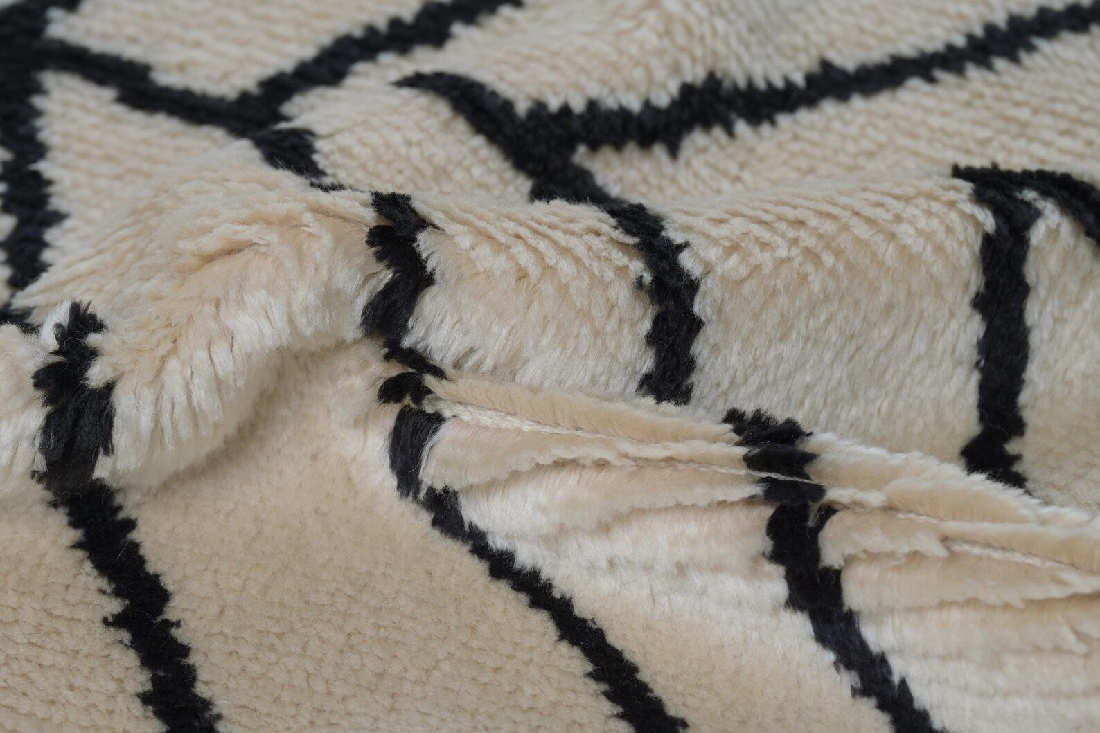 Product tag close-up of Stemline Rug showing brand label and hand-finished detailing.