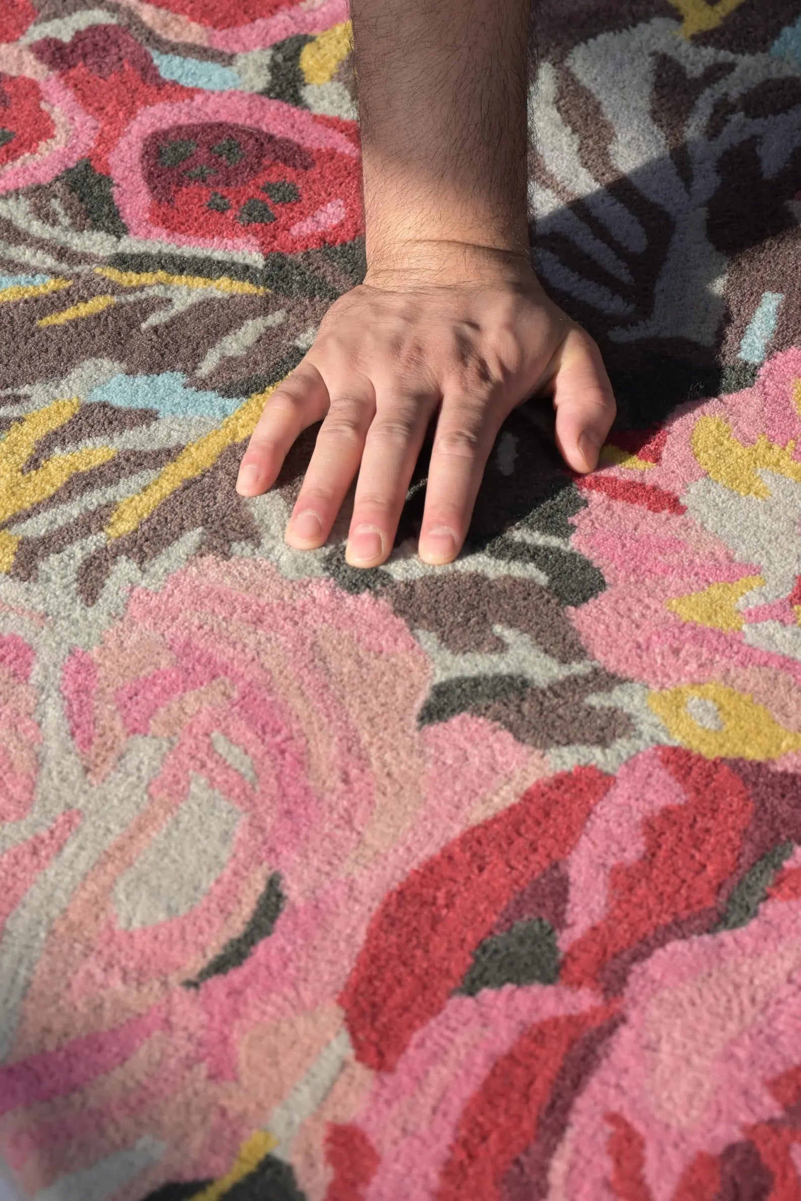 Detailed texture of Summer Bloom Area Rug with vibrant pink and green tones.