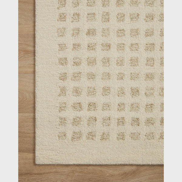 Side view of the Tessel Rug highlighting its fine woven edges and precise square detailing.