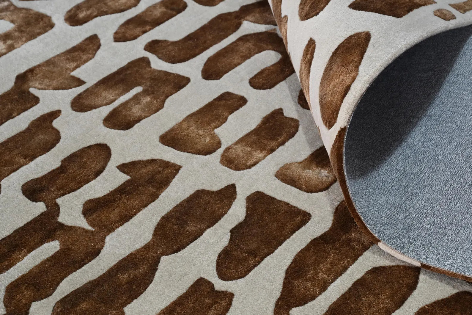 Close-up of Modern Tribal Rug highlighting raised brown tribal design and wool-like textured surface