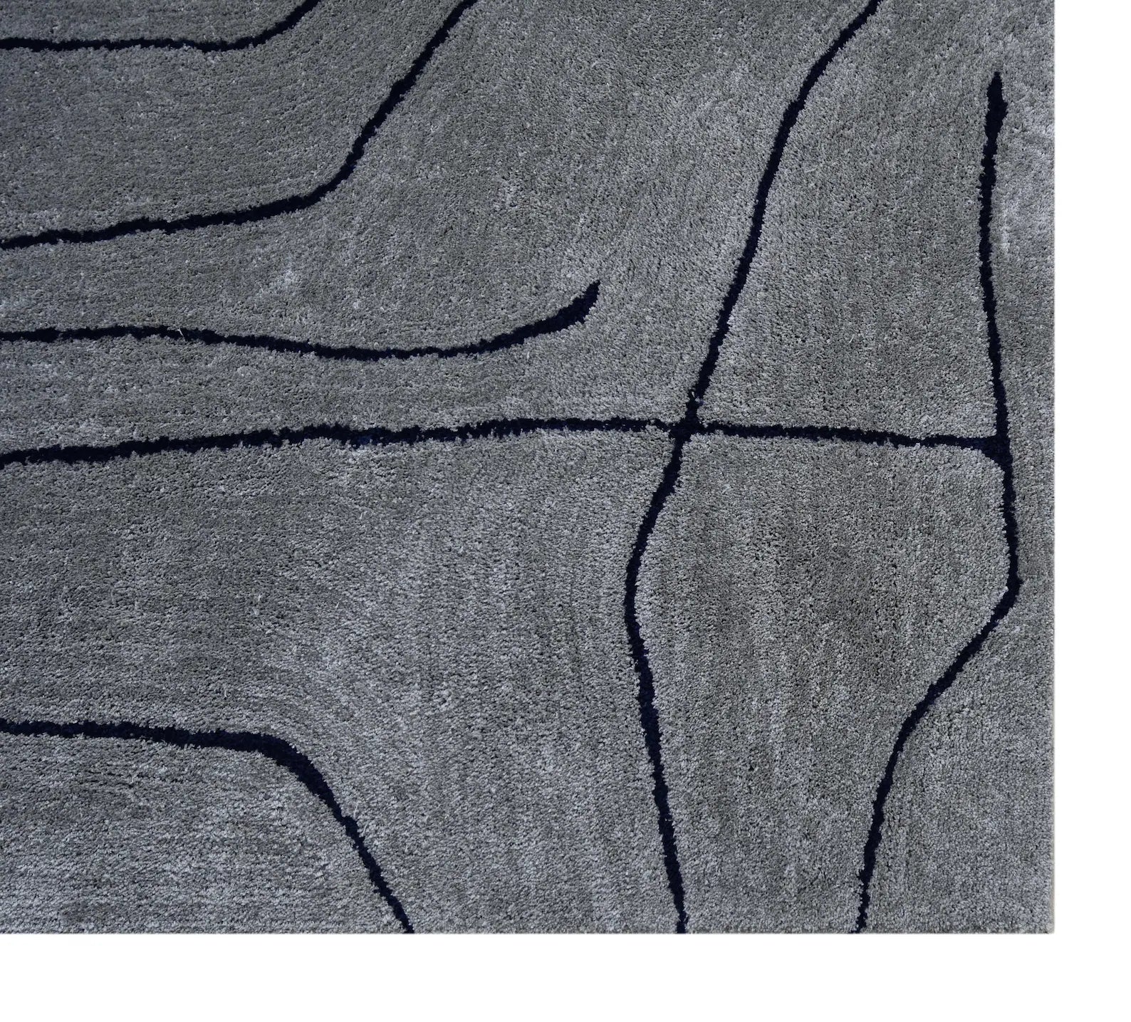 Texture close-up view of Abstract Line Art Grey Rug highlighting fine grey wool surface with dark abstract lines and soft hand tufted detailing