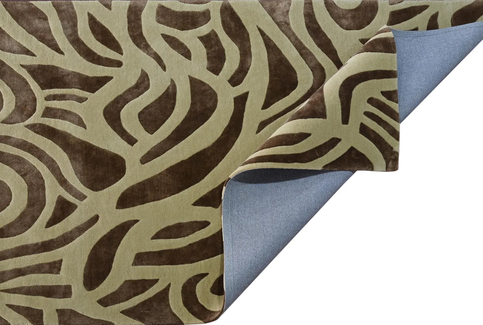 Close-up of Verona Rug showing soft cotton backing and curved fold that highlights its detailed weave.