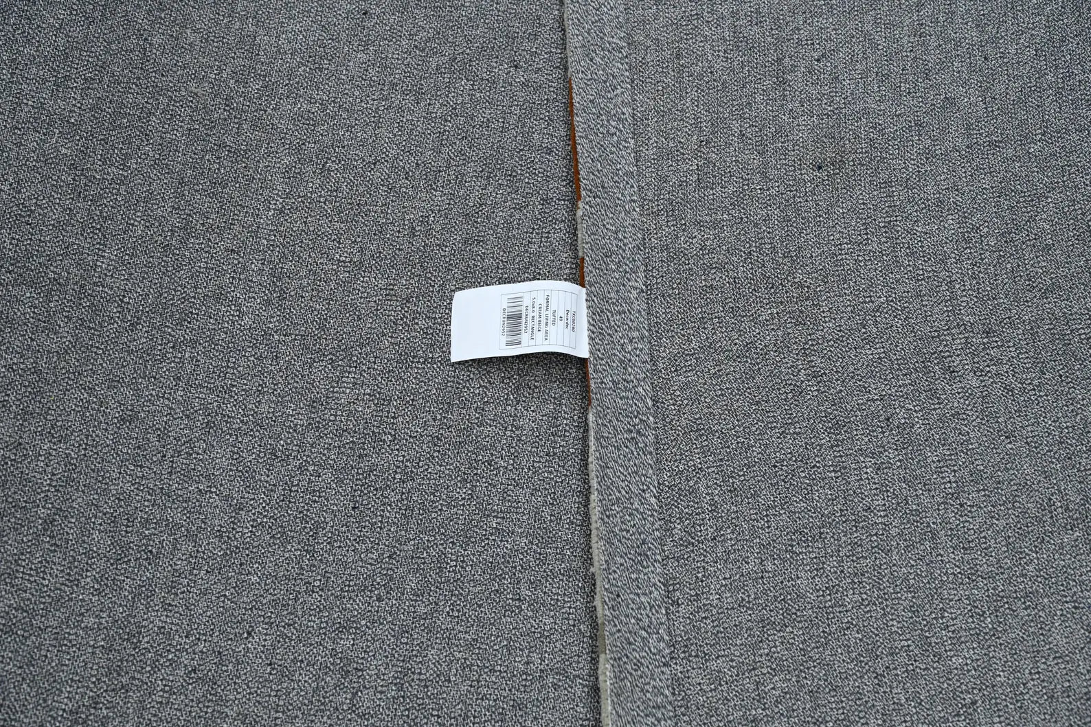 Backside of Vortex Distressed Rug showing smooth grey cotton backing with durable anti-slip texture for floor stability.