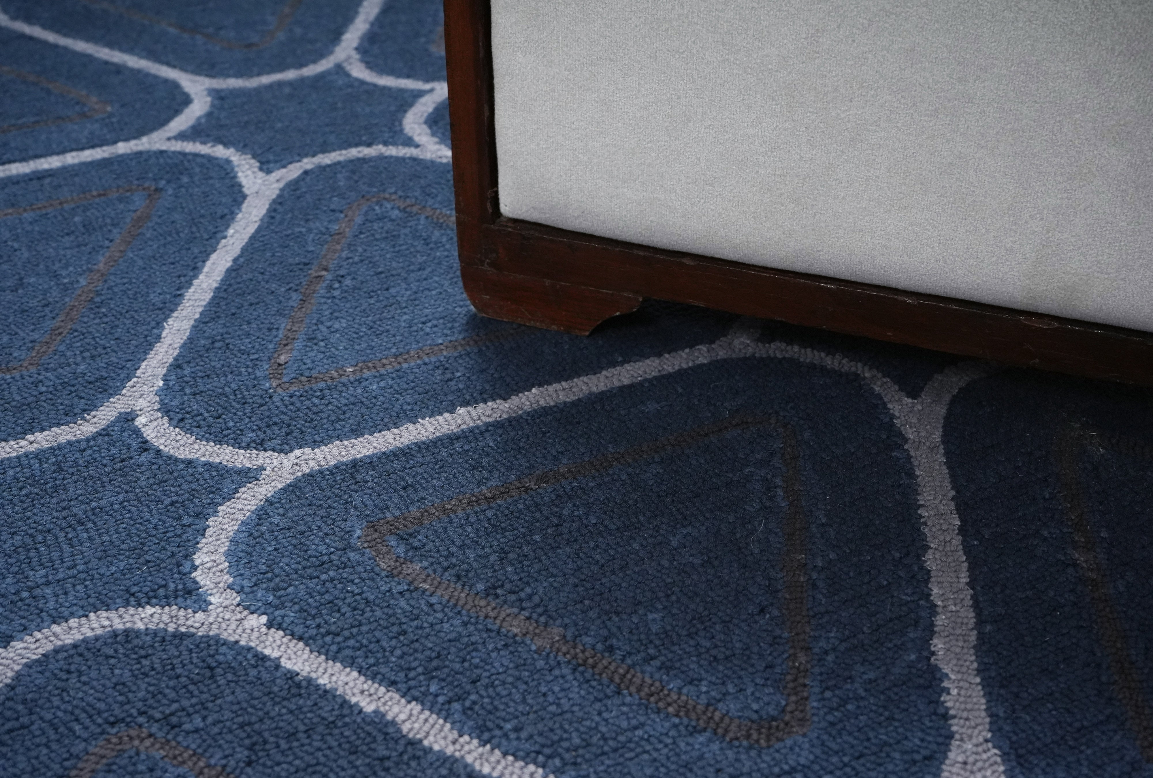 Surface texture detail of Arvelo hand tufted rug showing dense pile and modern geometric pattern.