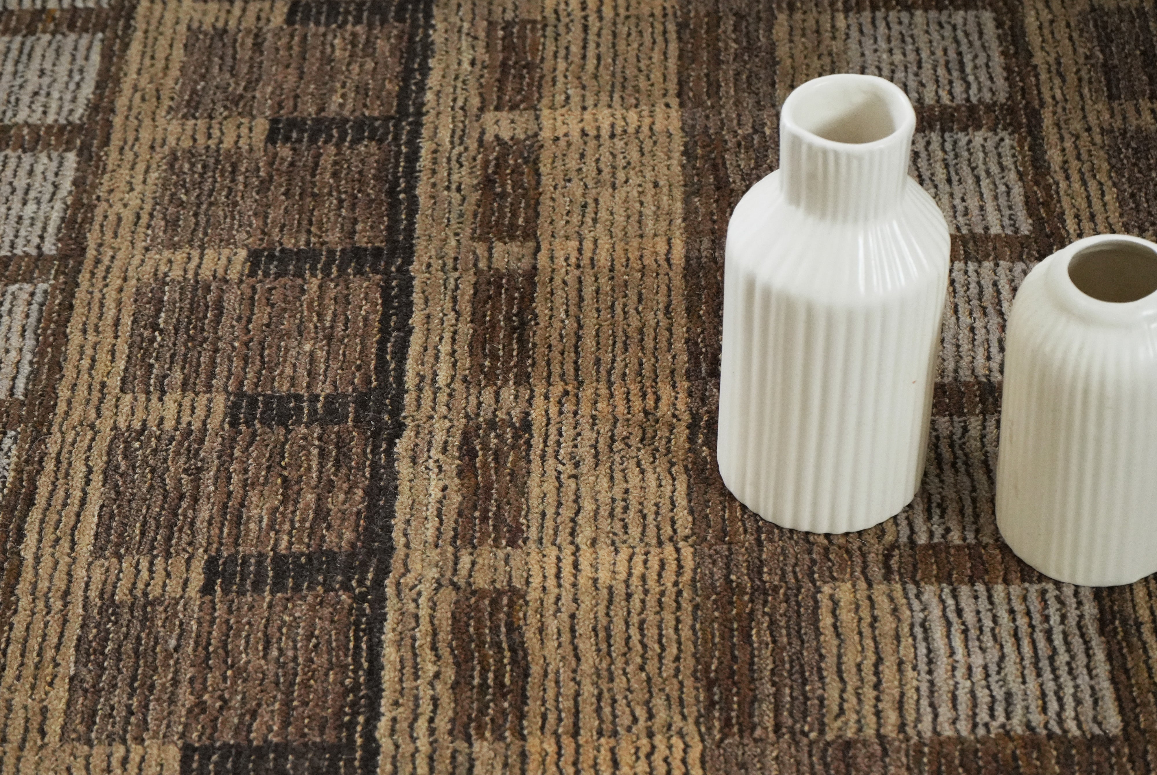 Textured surface of Bronte hand tufted rug in mocha and beige tones.