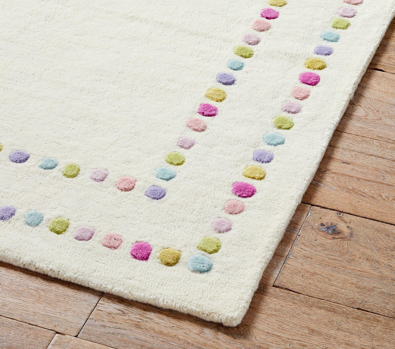 Candy Dots hand tufted rug corner view showing raised pastel dots and clean hand finished edge