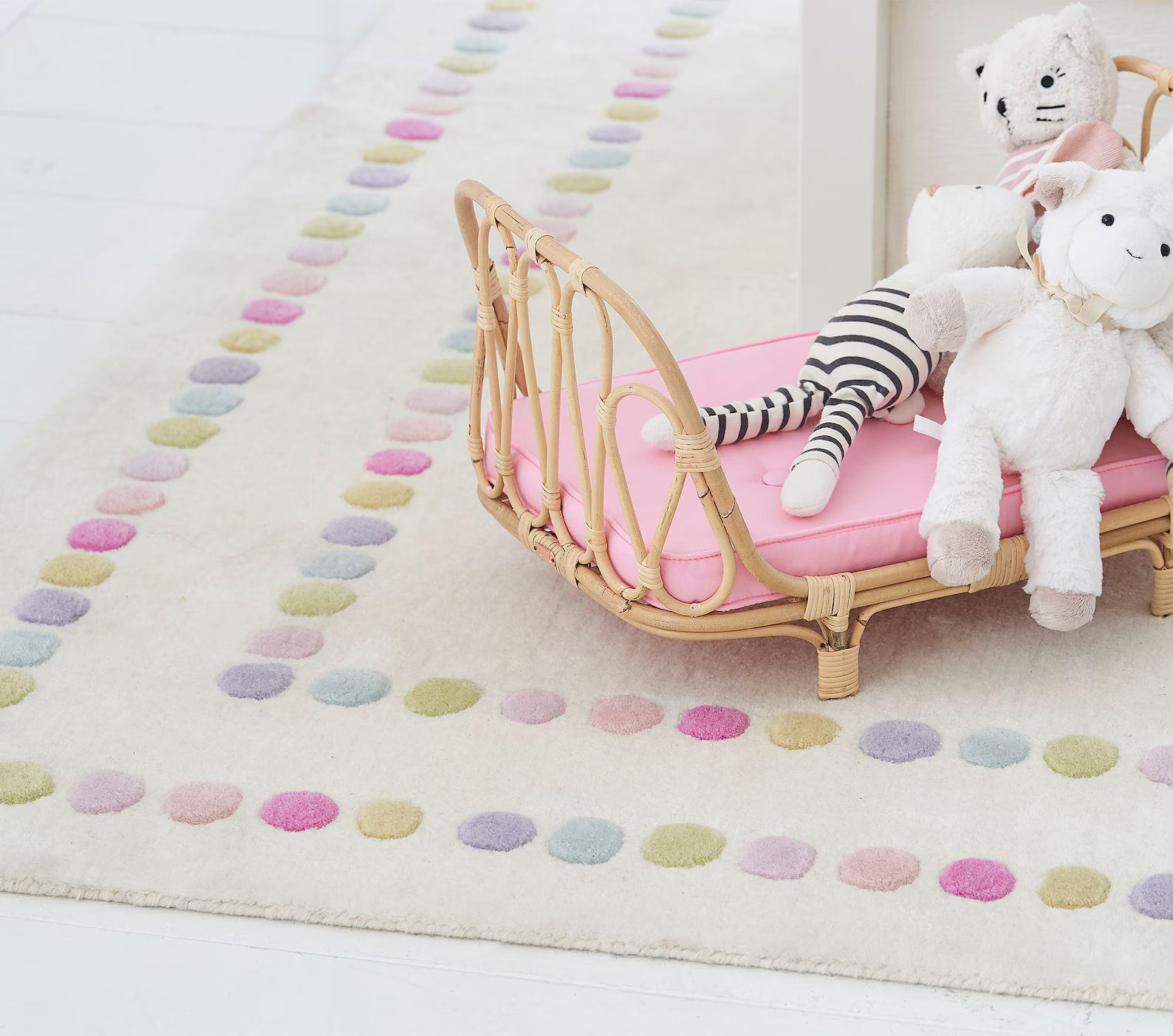 Candy Dots Rug styled in a playful kids room with pastel dots on a soft cream base