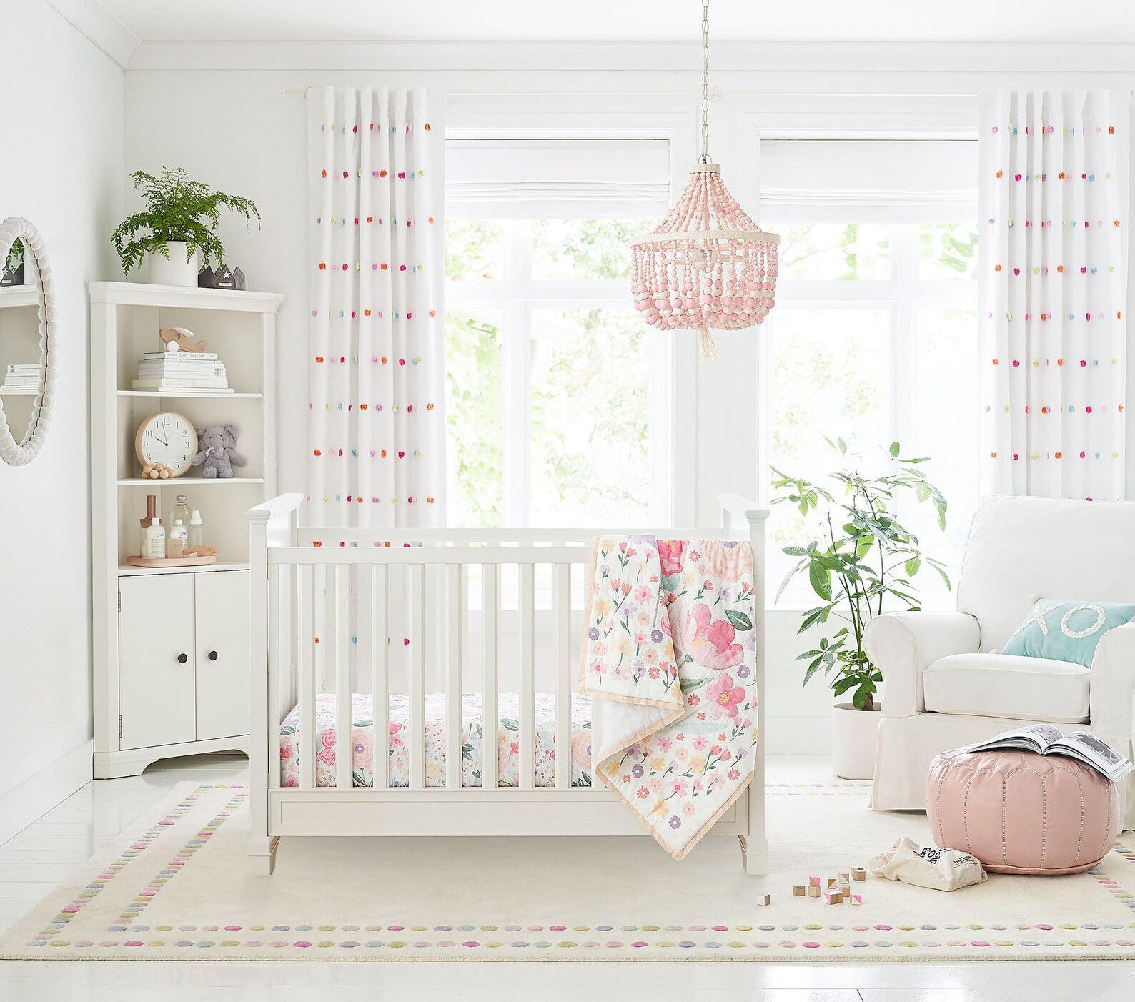 Candy Dots Rug styled in a cozy nursery with pastel accents and natural wood furniture
