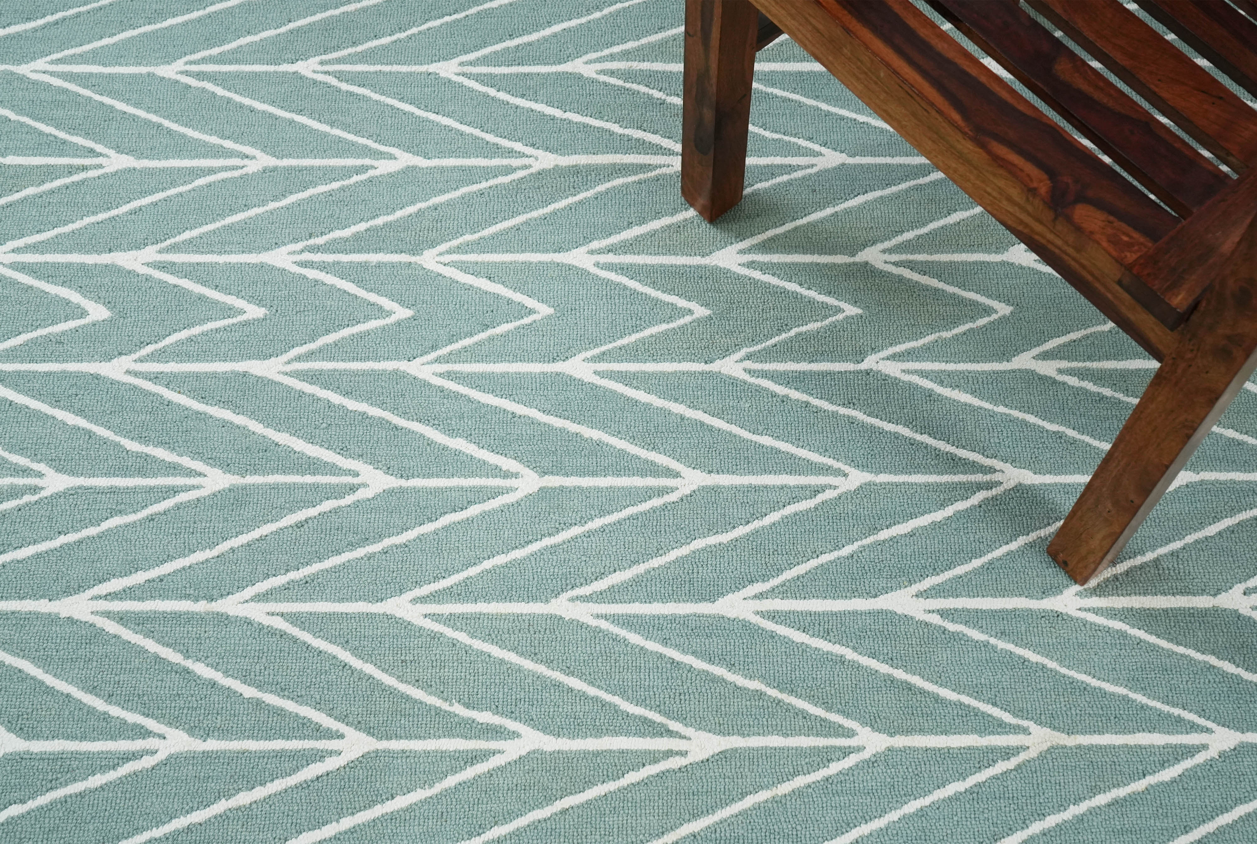 Chevron Drift hand tufted rug placed in a modern living room showing scale, color balance, and layout use