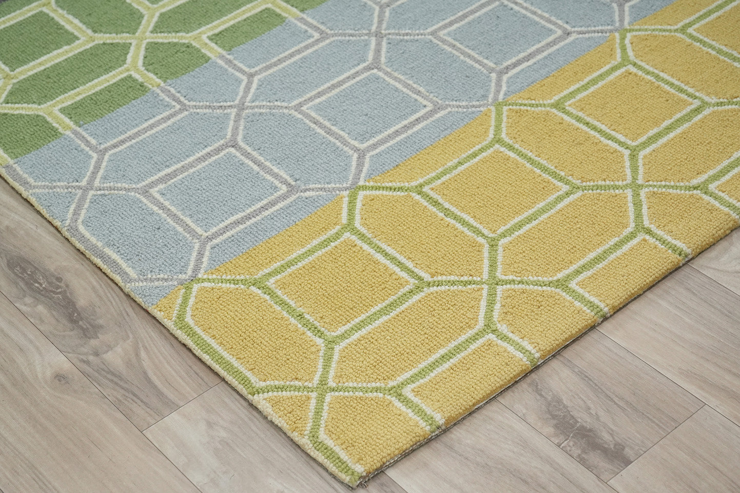 Colorband Wool Rug made from 100 % New Zealand wool with hand tufted construction shown from an angled corner highlighting layered color bands and geometric pattern structure