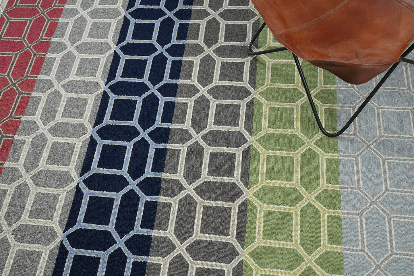 Colorband Wool Rug made from 100 % New Zealand wool with hand tufted construction shown in a lifestyle interior with multicolor horizontal bands and geometric lattice pattern 