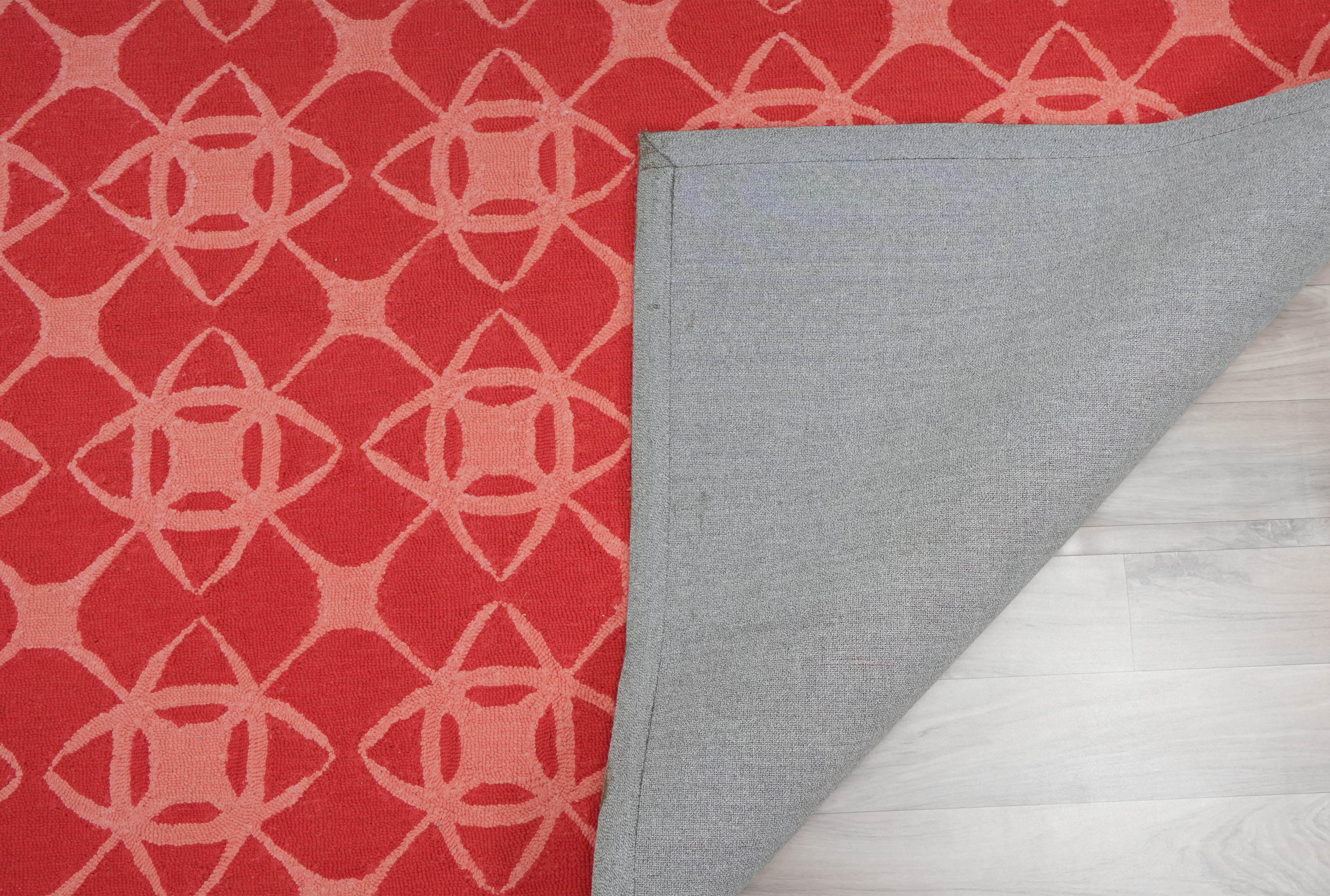Coral Cipher hand tufted wool rug backing detail showing cotton backing and coral geometric pattern
