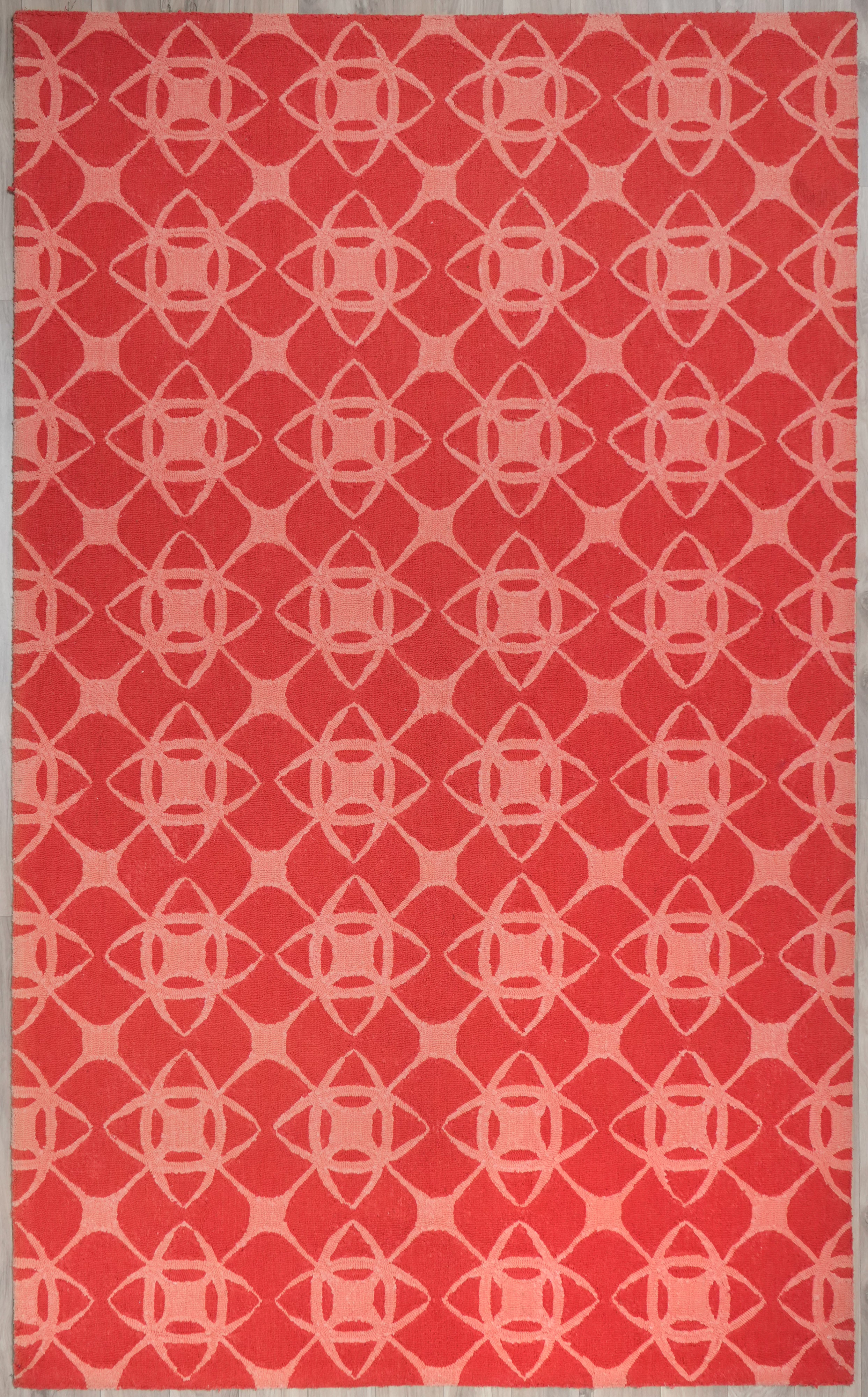 Full view of Coral Cipher hand tufted wool rug showing interlocking geometric pattern in coral and blush tones
