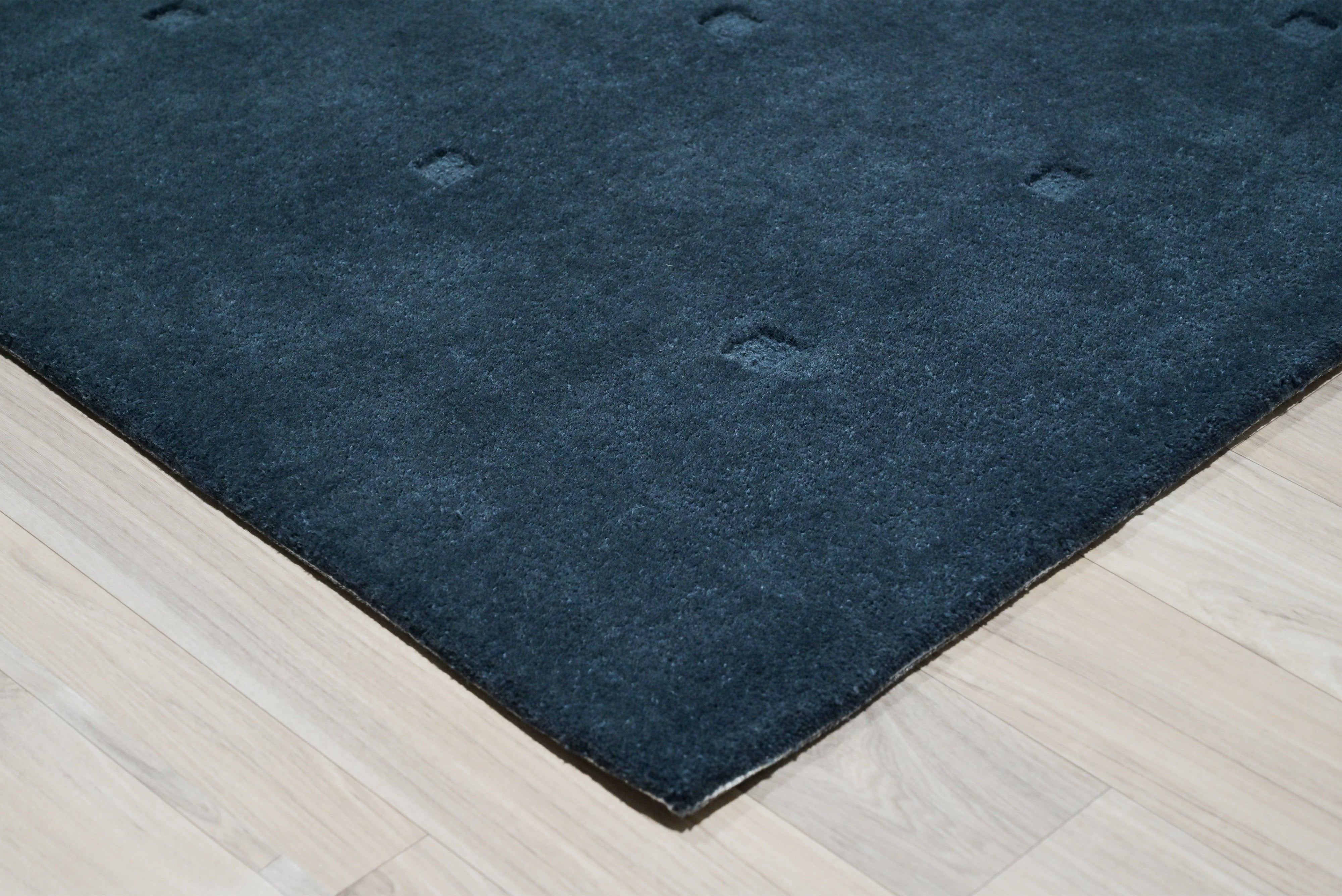 dark blue grid rug edge detail corner thickness and hand tufted finish