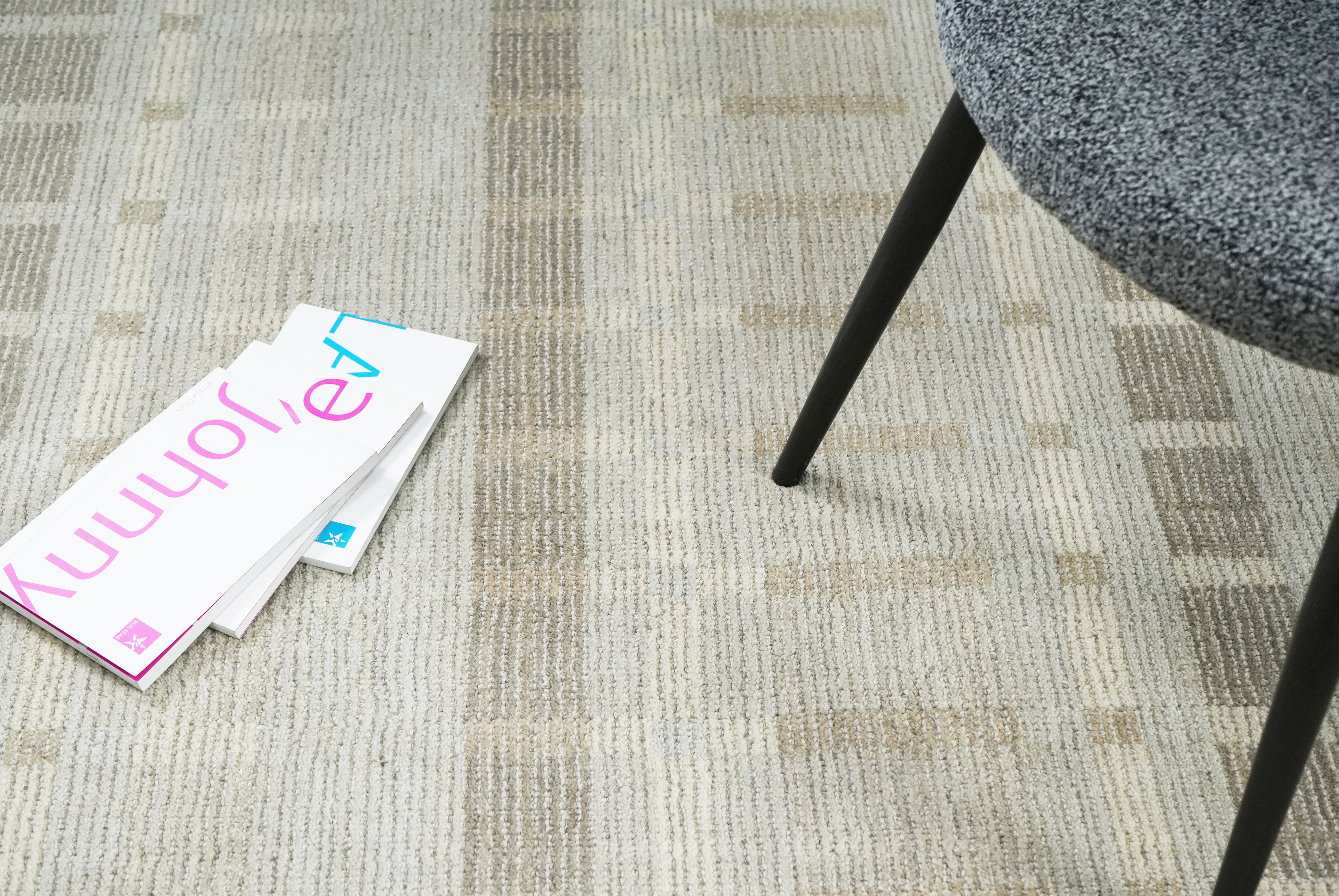 Elaron hand tufted rug in neutral textured design styled in modern living room.