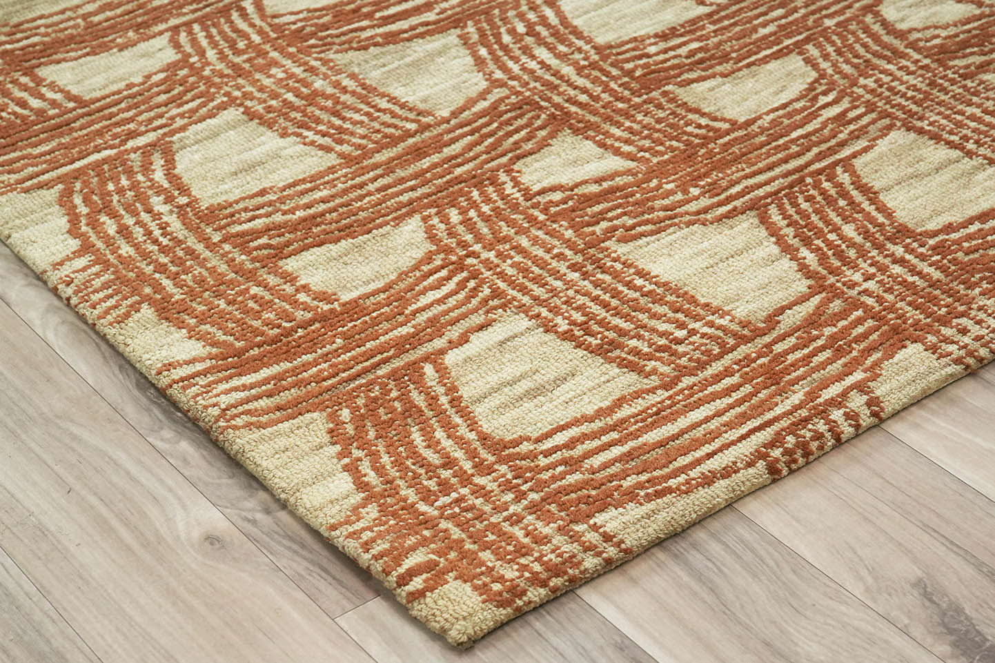 Angled corner view of Ember Weft Pattern hand tufted rug highlighting the woven texture and pattern depth