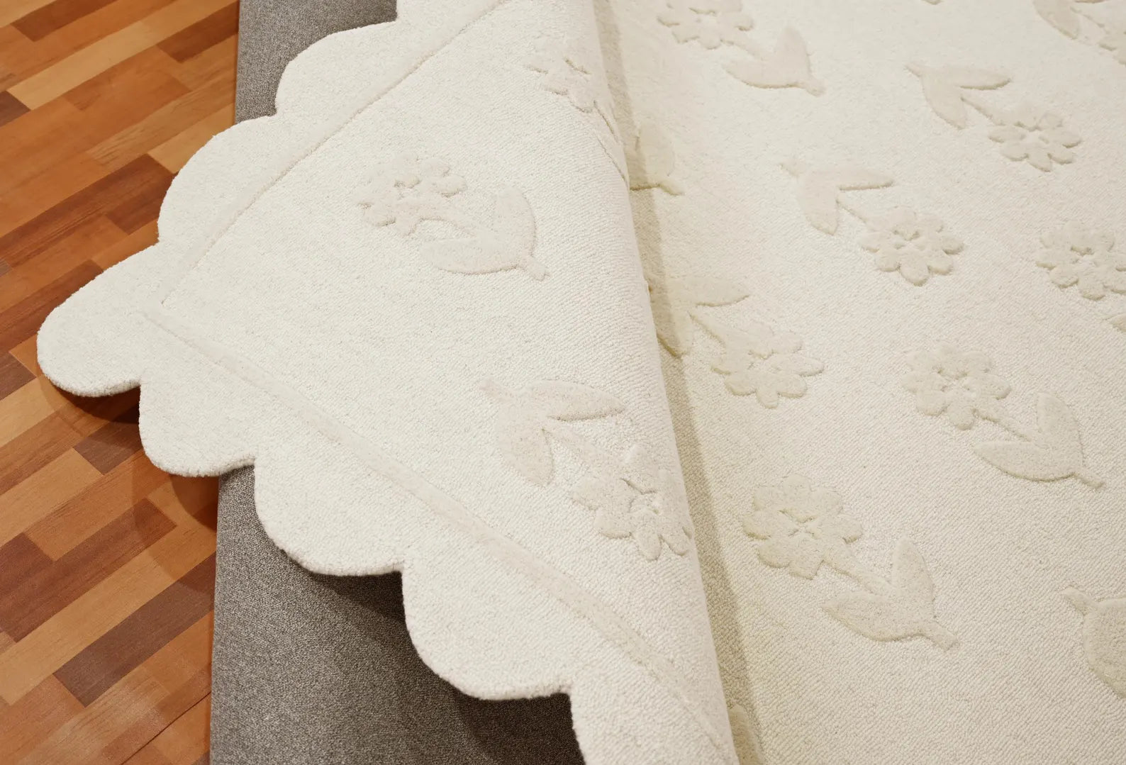 Flourish Hand tufted Rug texture closeup fold  showing intricate weave and elegant tone on tone finish