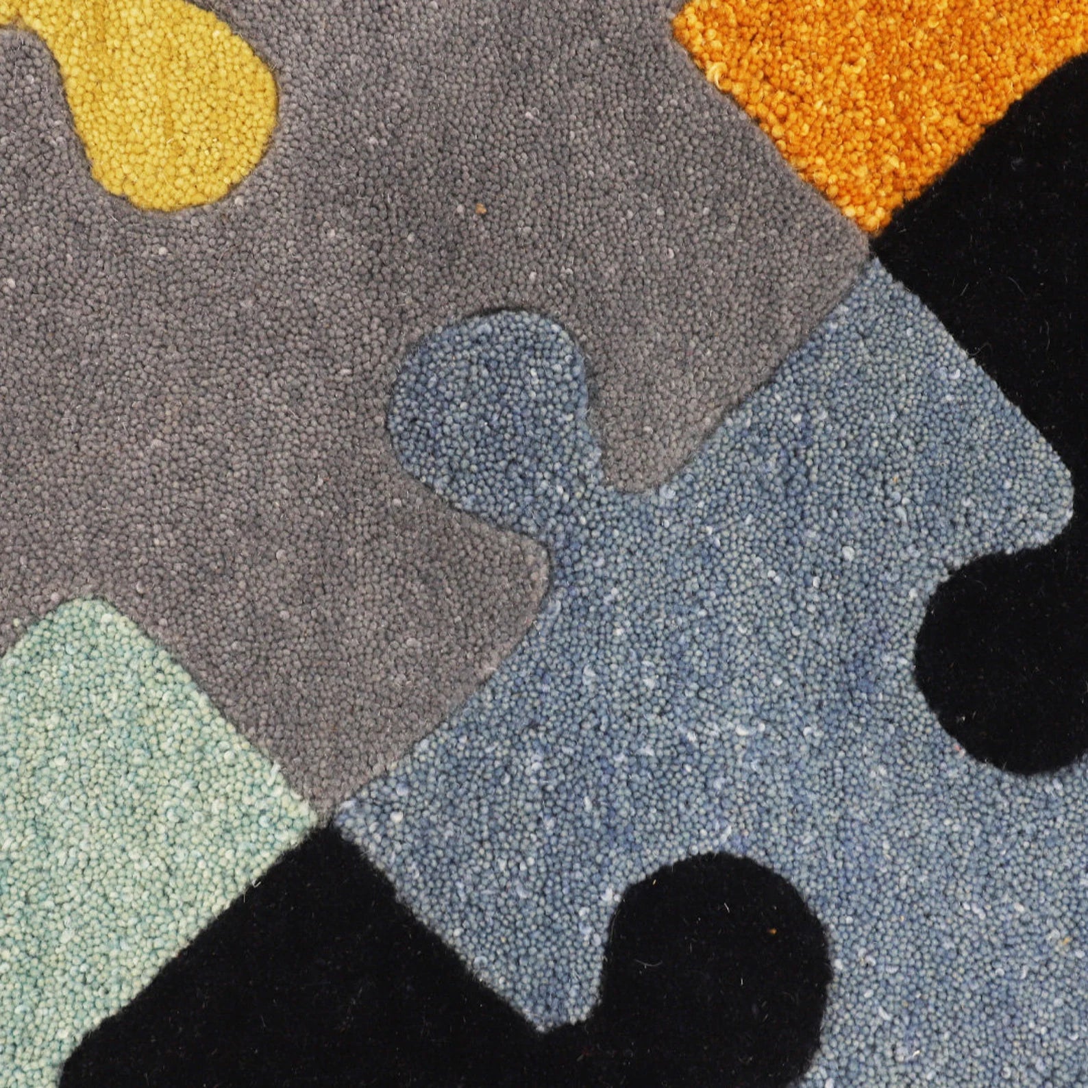 Close-up of the hand tufted Playgrid Rug highlighting thick pile and precise geometric detailing.