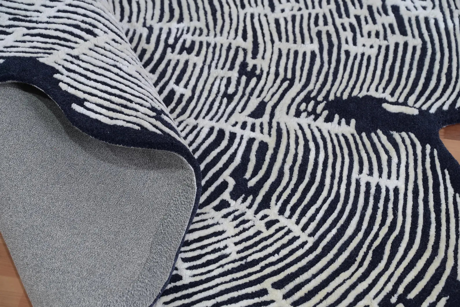 Hand tufted Sequoia Rug folded at the corner to display its durable wool backing and soft high-low texture detailing.