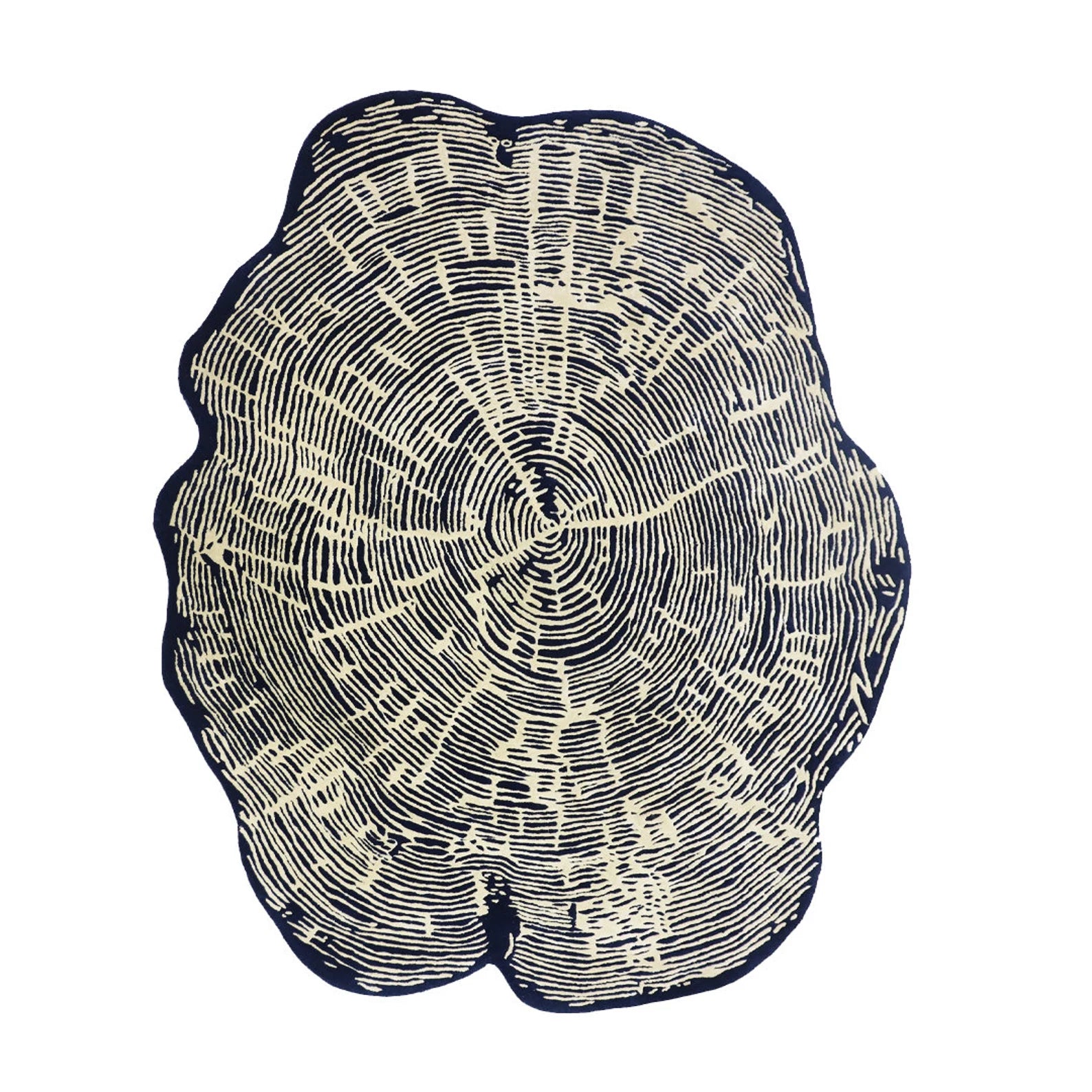Hand tufted Sequoia Rug displayed flat on a clean white background showing its complete irregular organic shape and tree-ring inspired white pattern on a dark base.