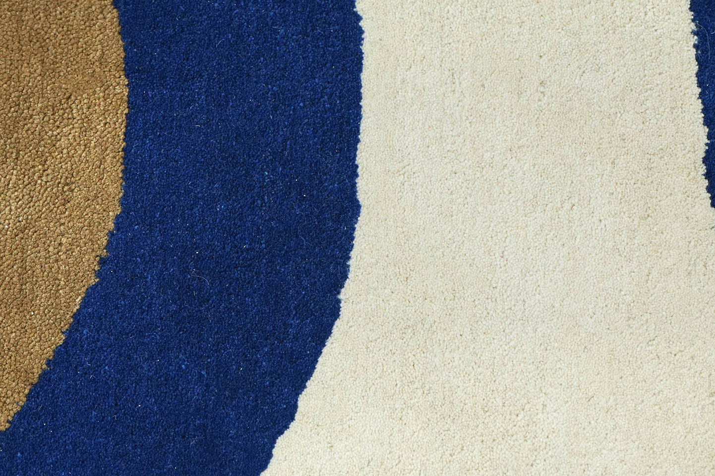 Close-up view of Interlinked Circle hand tufted rug highlighting connected circular forms and color contrast