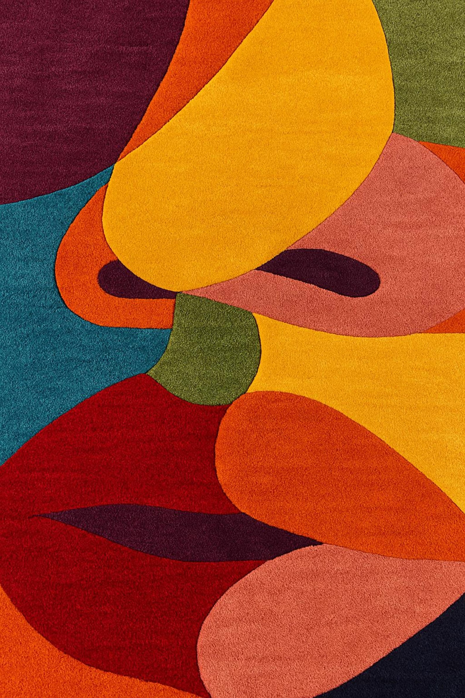 Close-up of The Kiss Modern Hand tufted Rug showing abstract color blocks in orange, deep navy, and red on a white background.
