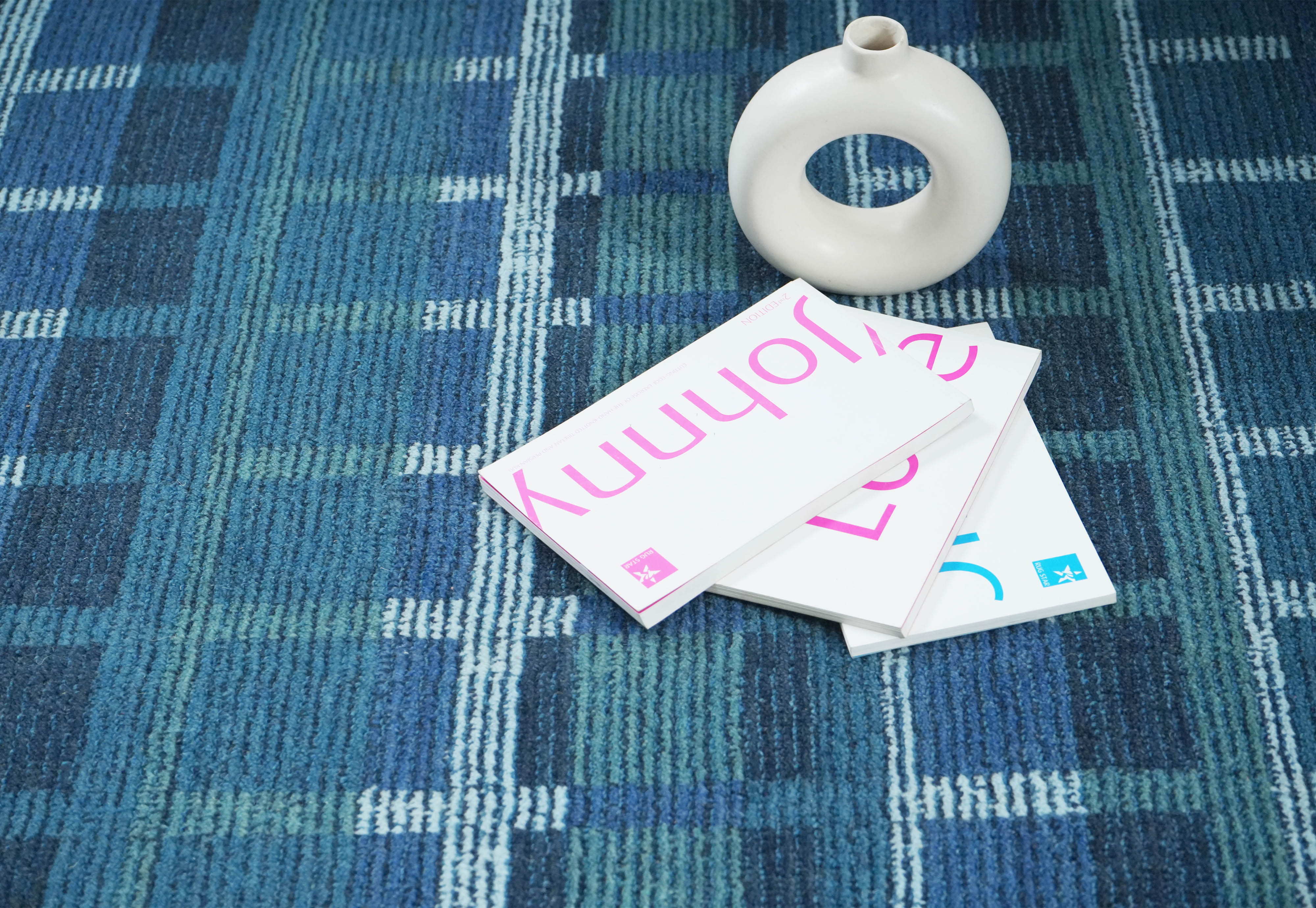 Lagoon Lattice blue wool hand tufted rug beneath modern chair in contemporary setting.