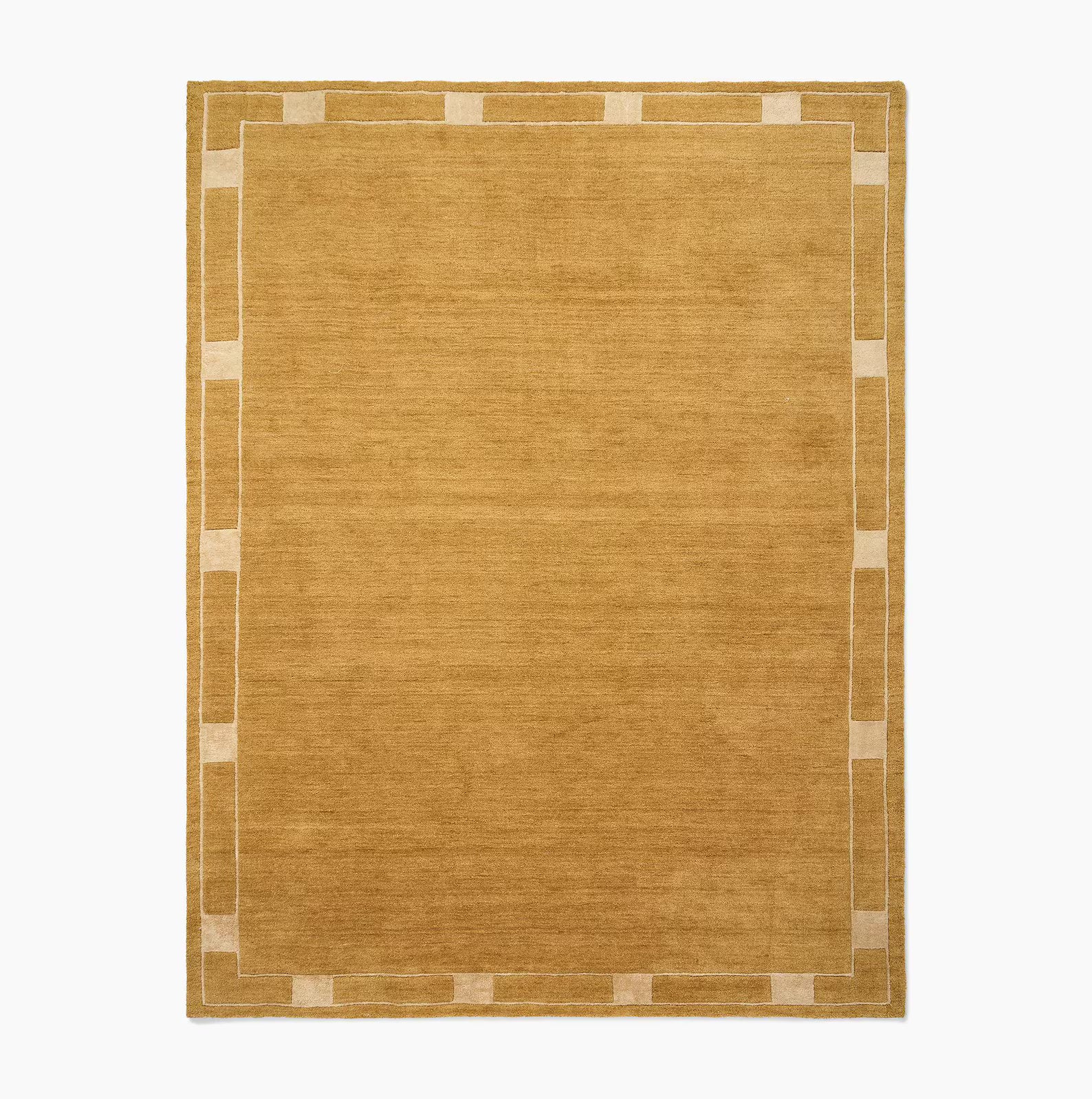 Full view of an ochre color mid-century modern rug with a stitched border, shown on a white background.