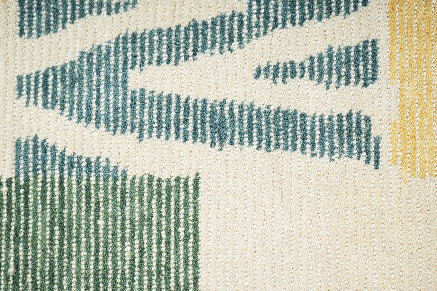 Mosaic Field Wool Rug made from 100 % New Zealand wool with hand tufted construction shown in close up detailing the woven texture and abstract geometric elements