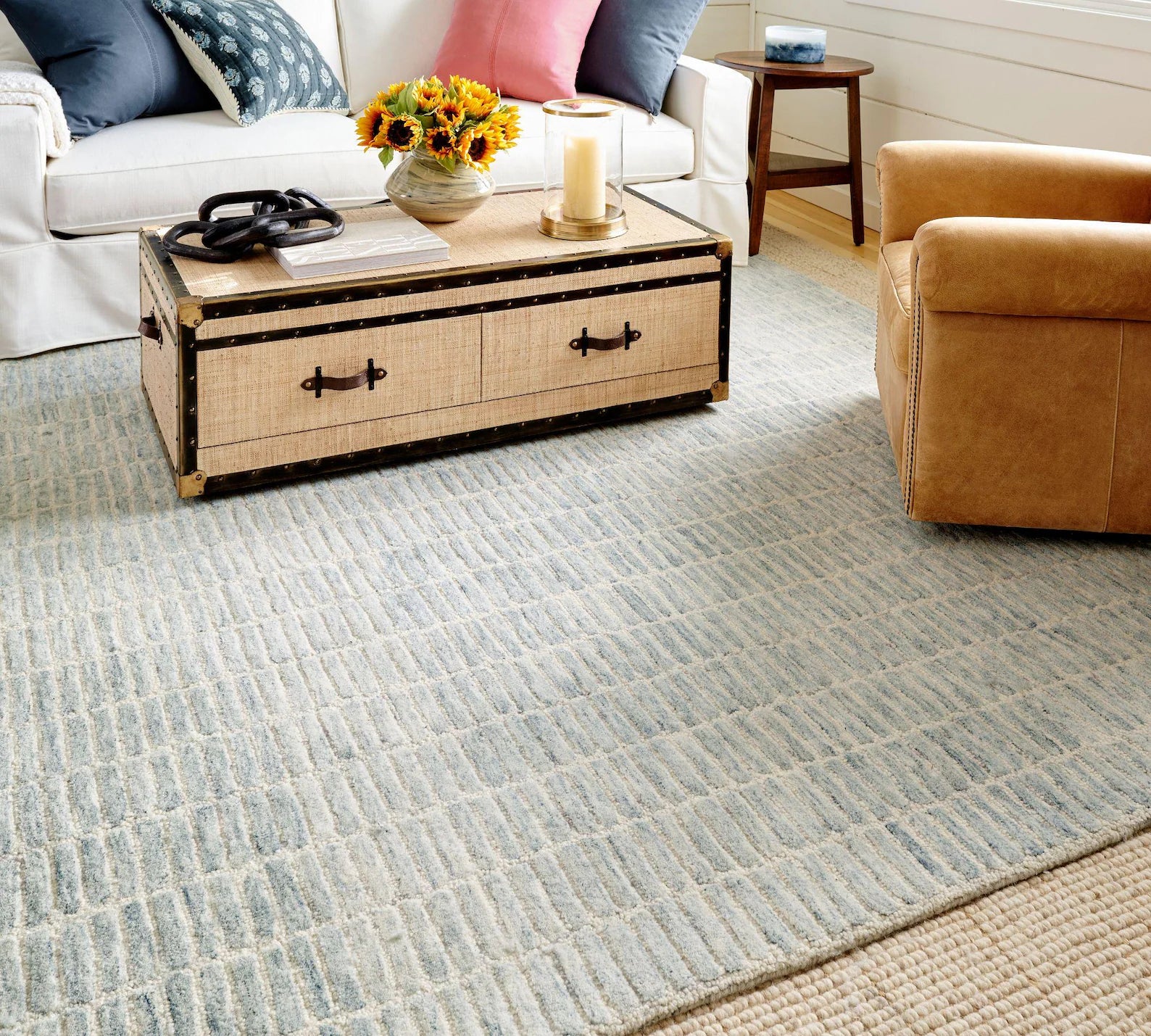 Ocean Breeze Rug styled in a living room with a neutral sofa, wooden coffee table, and accent chairs.