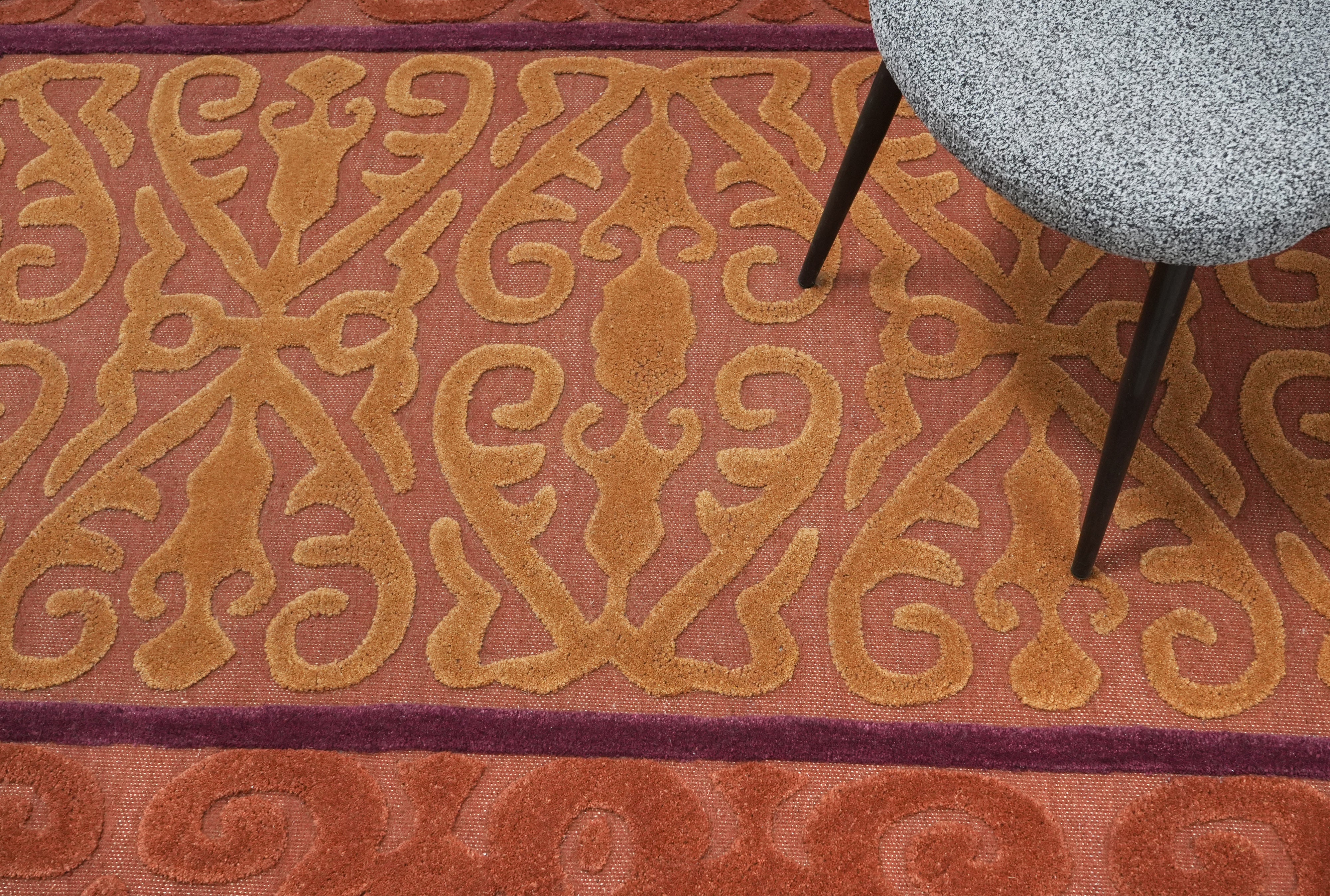 Saffron Dynasty rug close up of textured terracotta and mustard traditional motif