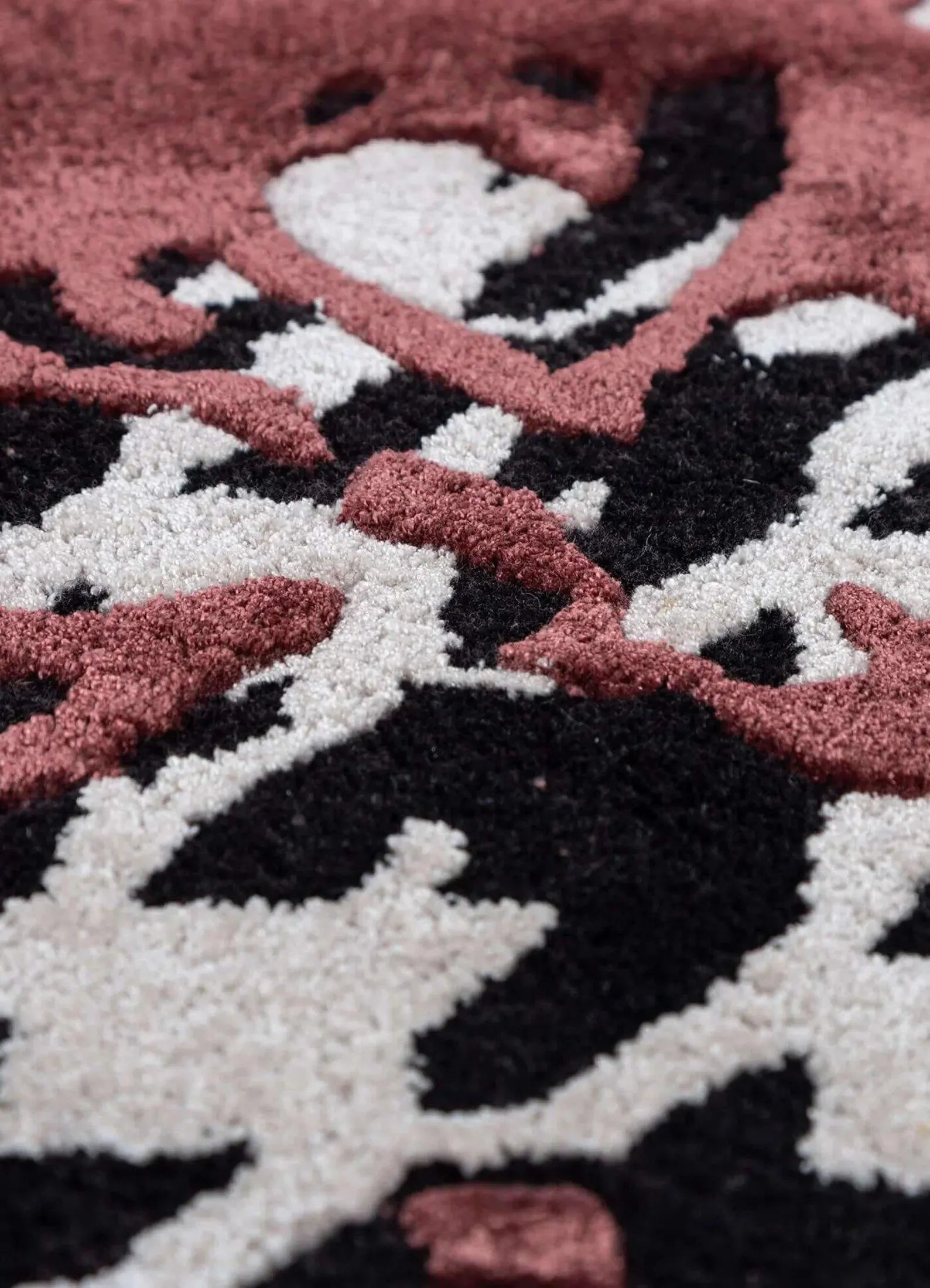 Split Houndstooth hand tufted rug closeup highlighting bold houndstooth design with red accent