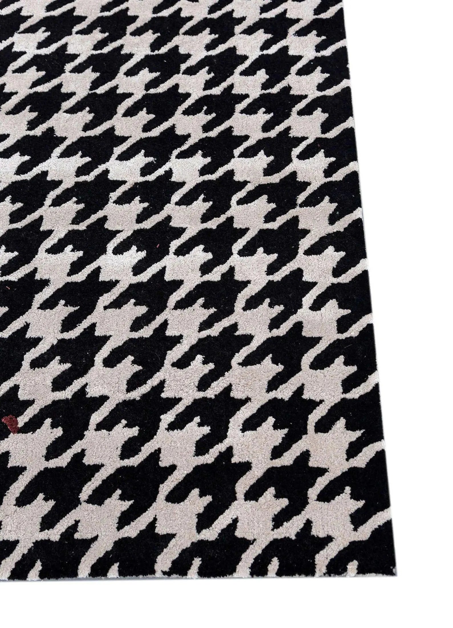 Split Houndstooth Rug closeup highlighting bold houndstooth design with red accent