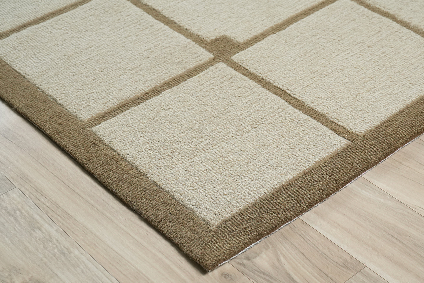 Square Field Wool Rug made from 100 % New Zealand wool with hand tufted construction shown from an angled corner highlighting grid alignment and tonal contrast