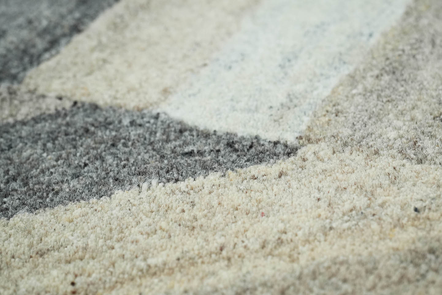 close-up of Strata Shift Rug showing layered stripe texture and neutral color variation