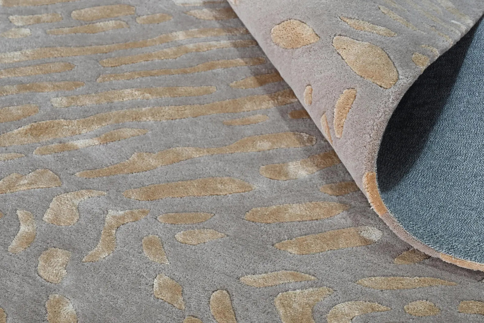 Swirl Pattern hand_tufted_rug side folded corner showing soft wool texture and strong backing 