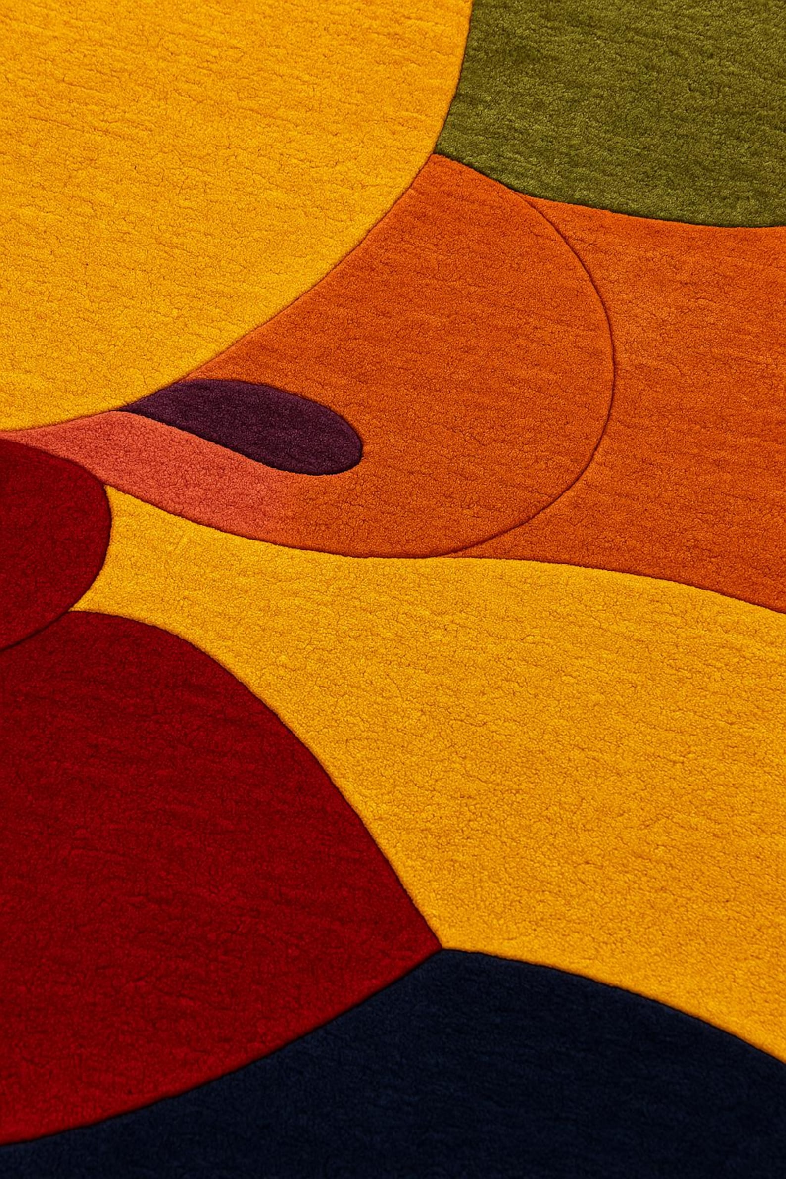 Close-up of The Kiss Modern Rug showing abstract color blocks in orange, deep navy, and red on a white background.