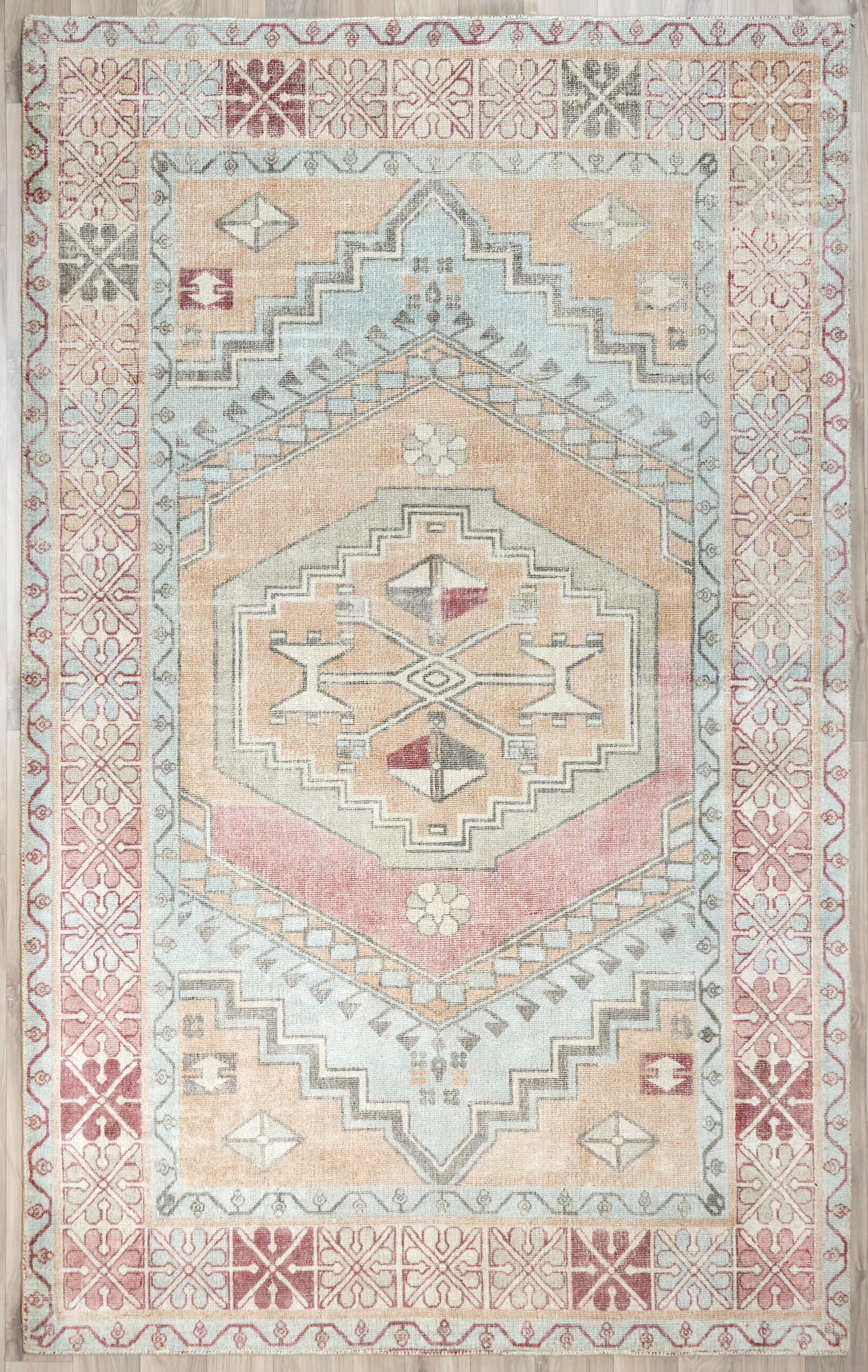Willowmere wool hand tufted rug vintage medallion design in blush soft blue sand beige and ivory