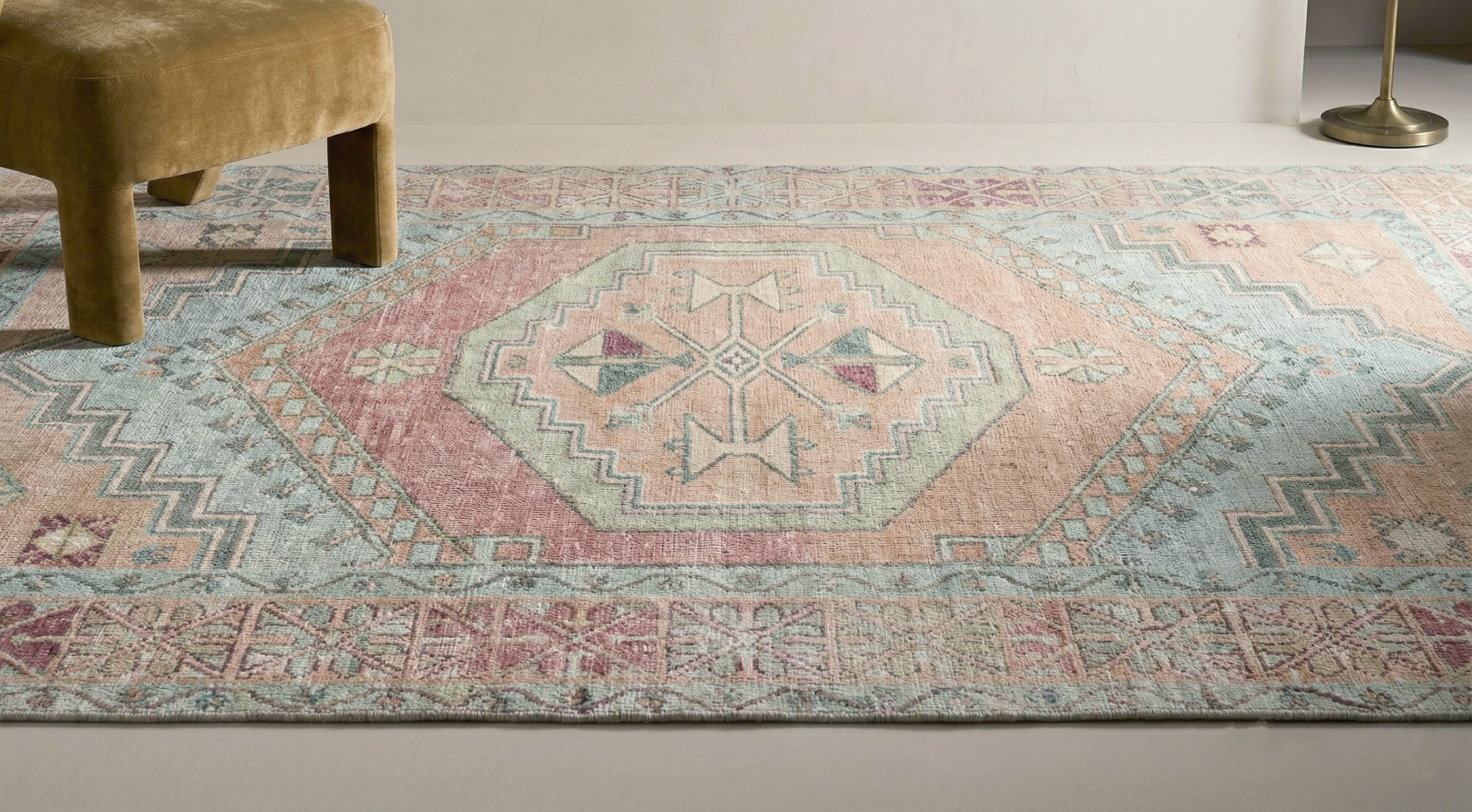 Willowmere wool hand tufted rug vintage medallion pattern in blush soft blue sand beige and ivory placed in a modern interior